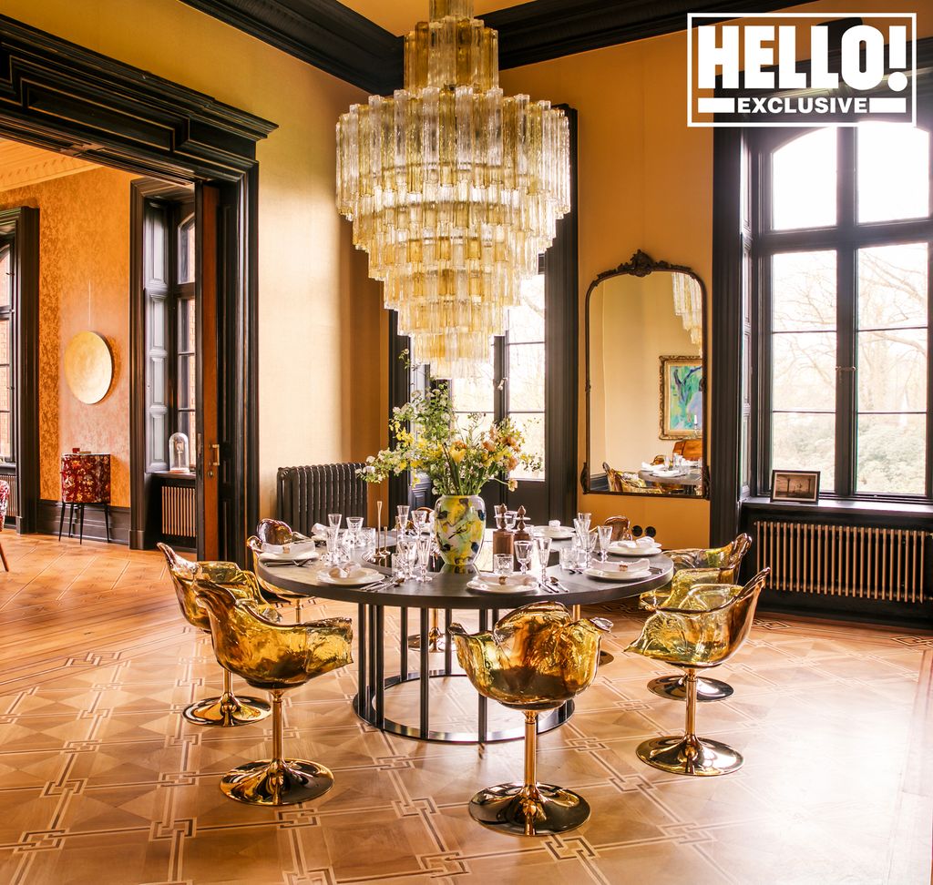 Round dining table with clear yellow chairs and a chandelier