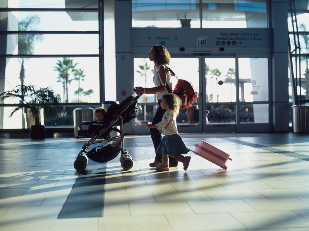 woman with child and pushchair in airport