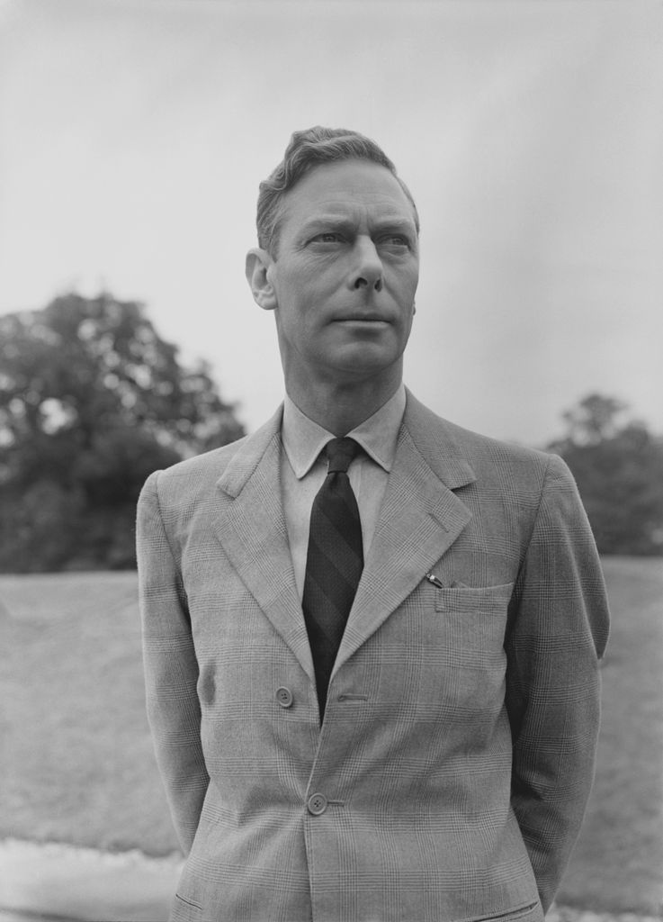 Black and white photo of King George VI in a field