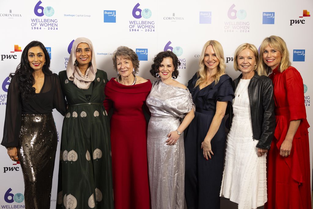 group of women smiling in formal clothes