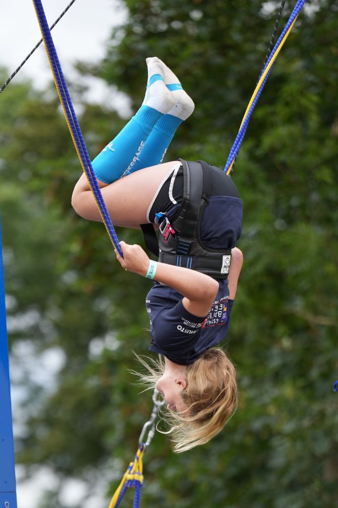 Savannah Phillips performing a flip on a bungee trampoline