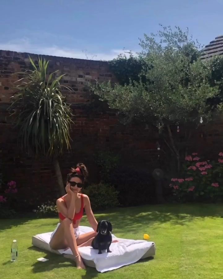 Michelle Keegan in a red bikini in the garden with her dog Phoebe