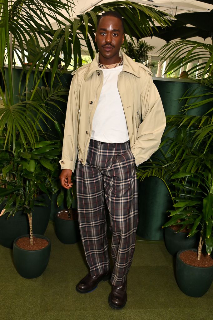 Ncuti Gatwa wears beige zip jacket, white t-shirt and check wide-leg trousers at Chelsea Flower Show 2025 Burberry dinner.