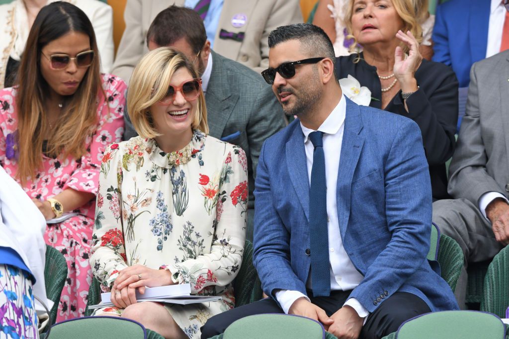 Jodie Whittaker and husband Christian Contreras laughing in the stands at Wimbledon