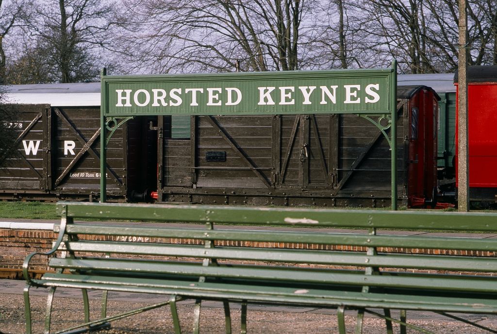 Green Horsted Keynes train station sign with green bench