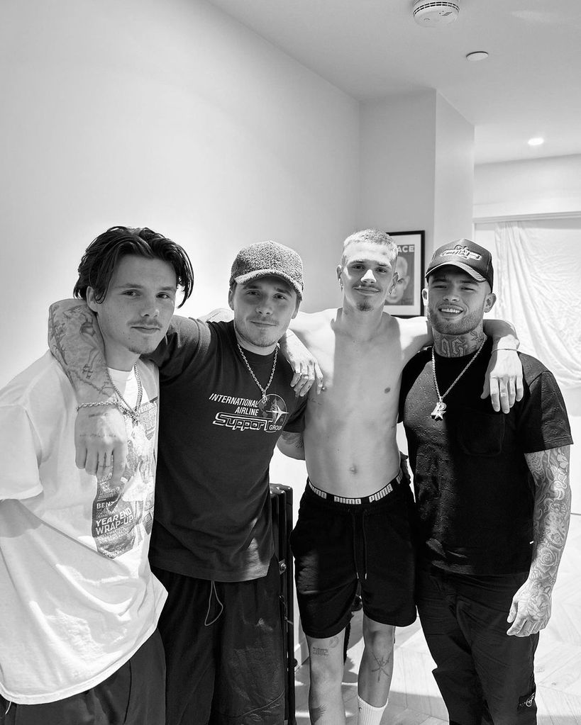 The Beckham brothers posing with tattoo artist Pablo