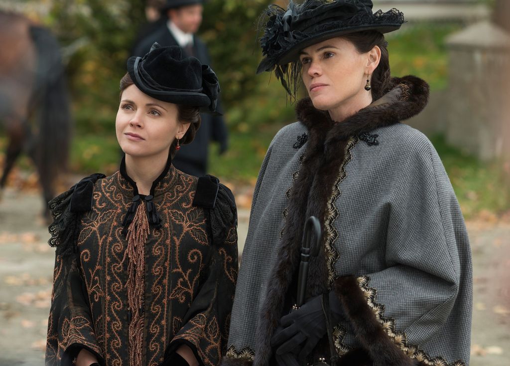 two women in dark period clothing