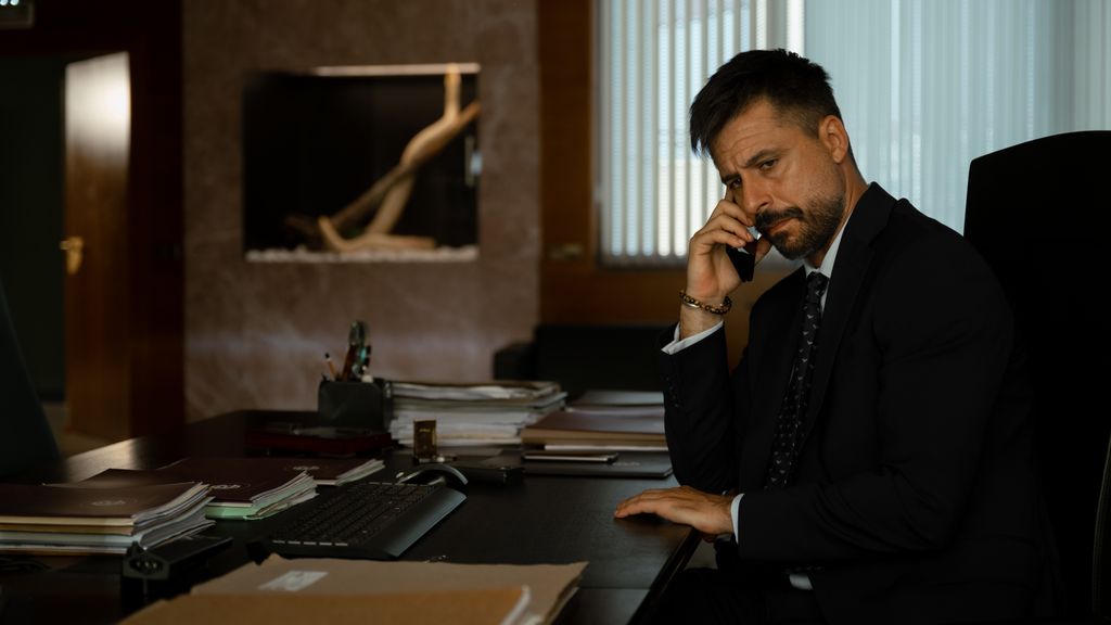 man in suit sitting at desk 