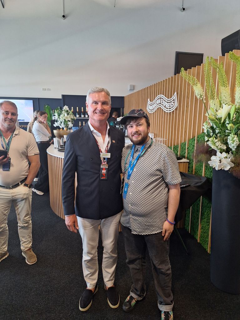 David Coulthard standing with a journalist