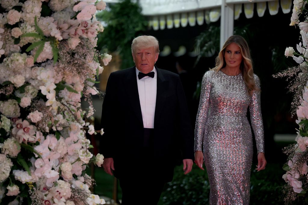 President Donald Trump and former first lady Melania Trump arrive for a New Years event at his Mar-a-Lago home on December 31, 2022 