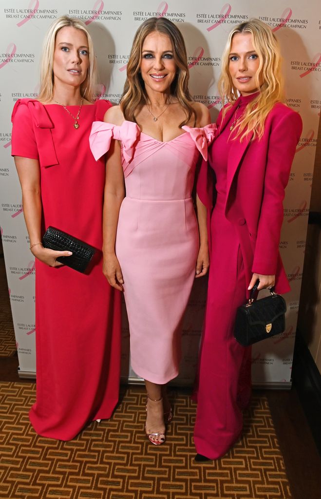 amelia and eliza spencer in hot pink looks with Elizabeth Hurley in pink dress between them