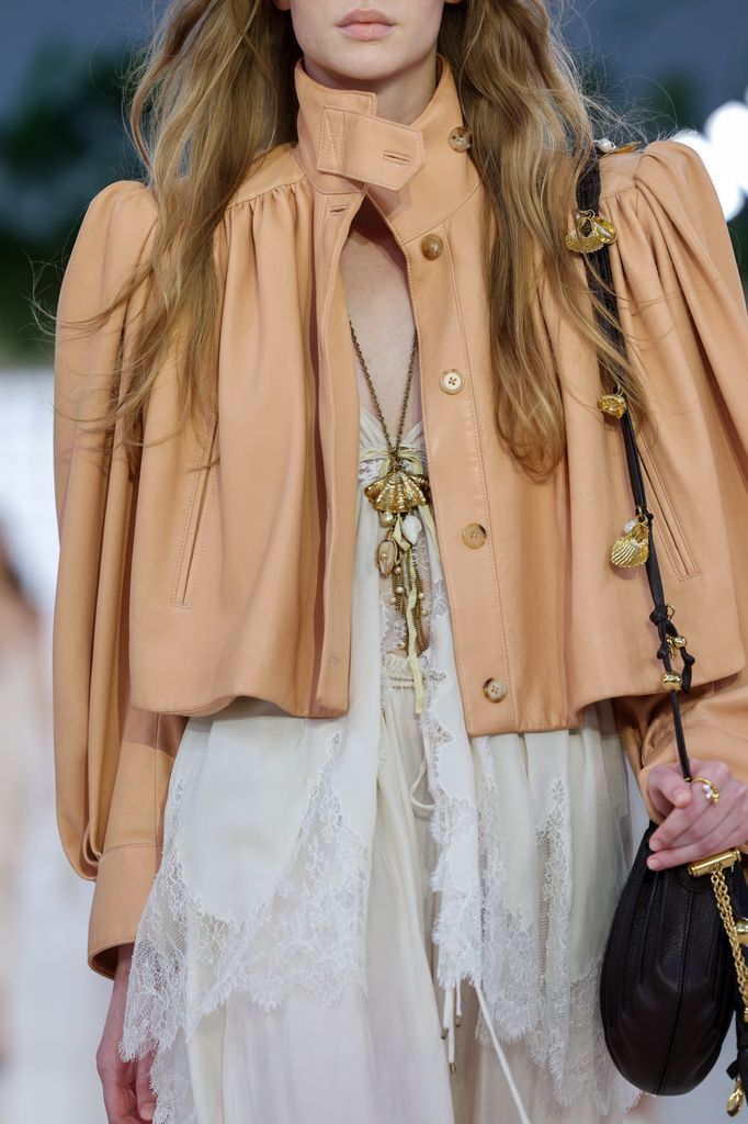 Model wearing shell necklace on Chloé runway