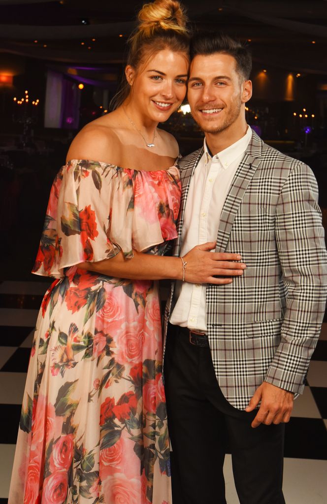 Gemma Atkinson in a pink off-the-shoulder dress with and Gorka Marquez in a checked blazer