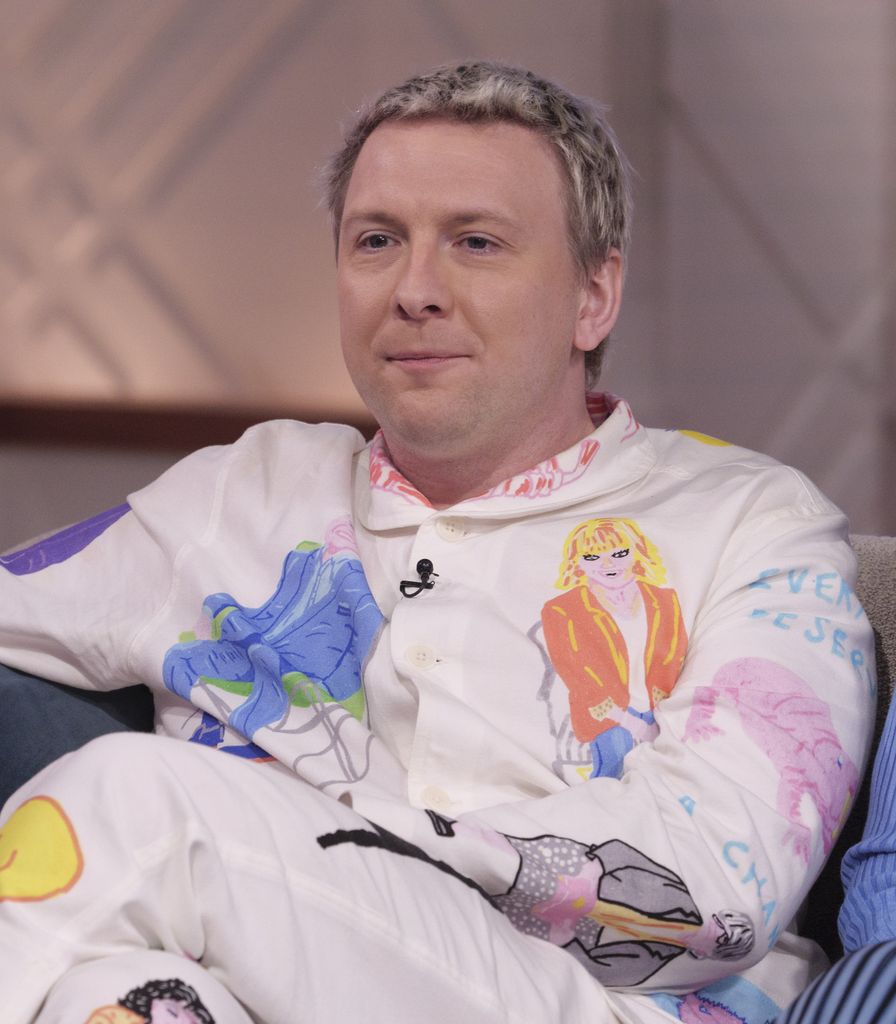 Joe Lycett in a white outfit