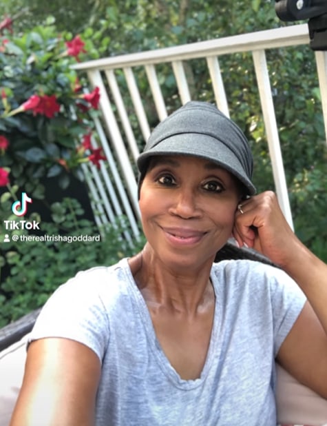 Trisha Goddard takes selfie while sitting in her garden