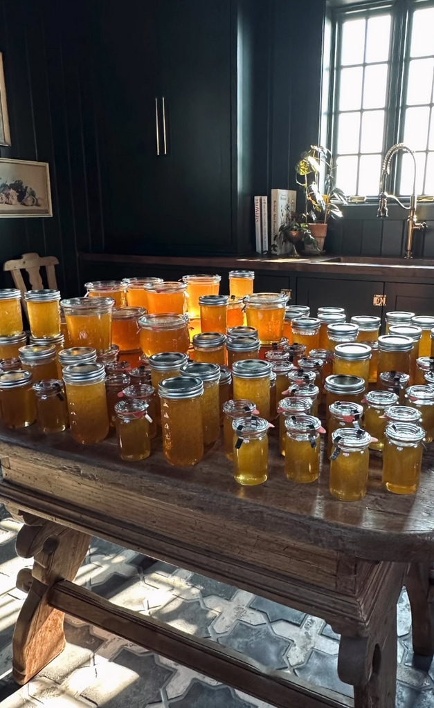 Still from a video shared by Joanna Gaines on Instagram August 2023 which pictures a stack of jars of honey on her kitchen counter, after harvesting it from her bee farm with her son Crew. 