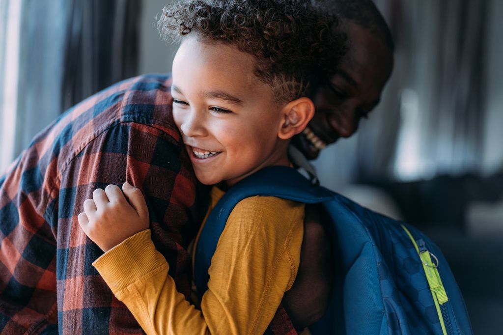 Cute boy with his father on the first day of school.