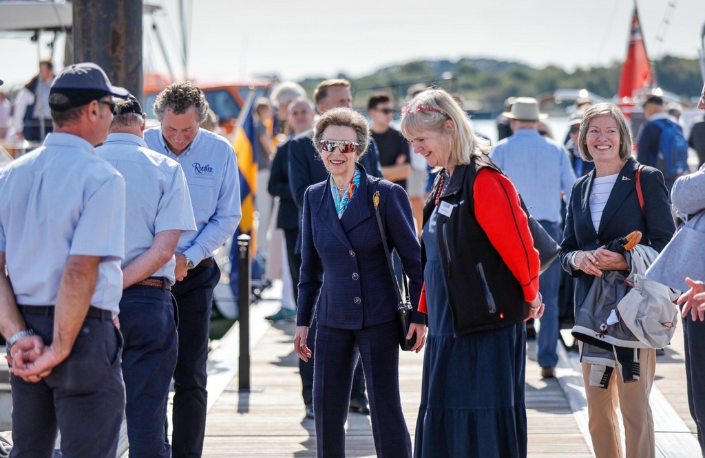 Princess anne in wraparound shades with people on marina