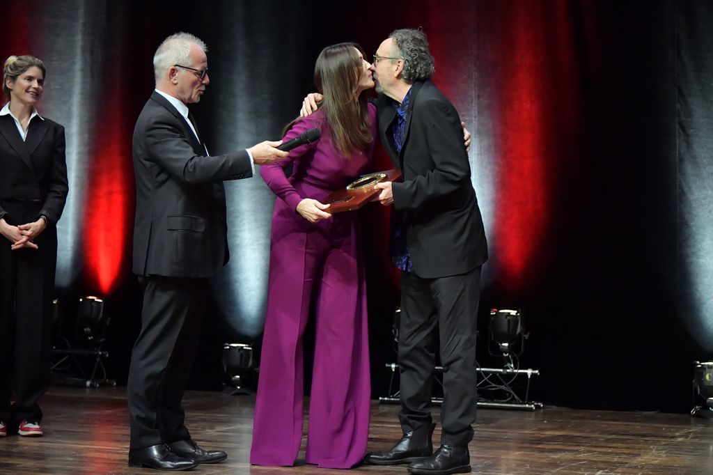 Tim Burton receives the Lumiere Award from the hands of Monica Bellucci during the award ceremony of the 14th Film Festival Lumiere on October 21, 2022 in Lyon, France.