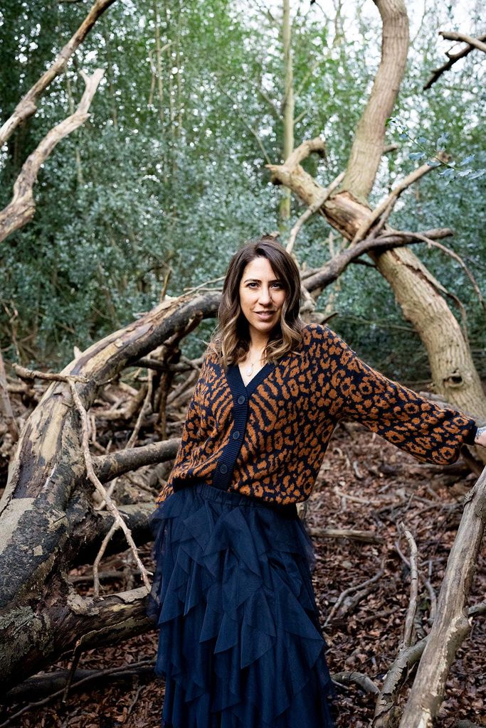 Woman in the woods in patterned cardigan