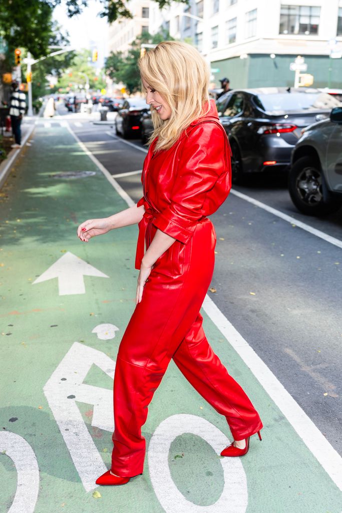 Kylie walking in her red jumpsuit 
