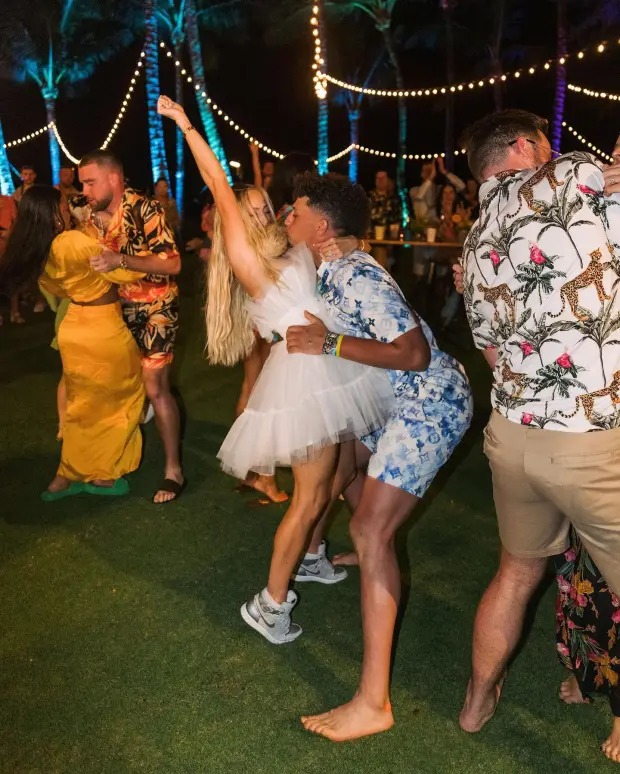 Patrick Mahomes and wife Brittany dance in the foreground, and in the background Travis Kelce dances with Kayla Nicole