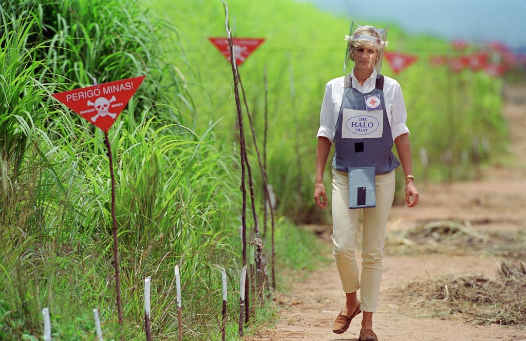 Diana, Princess of Wales wearing protective body armour and a visor visits a landmine minefield being cleared by the charity Halo in Huambo