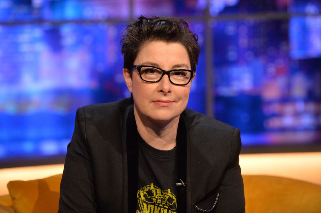 Sue Perkins sitting on a yellow sofa