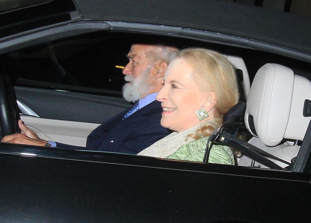 Princess Michael smiles in passenger seat as Prince Michael drives
