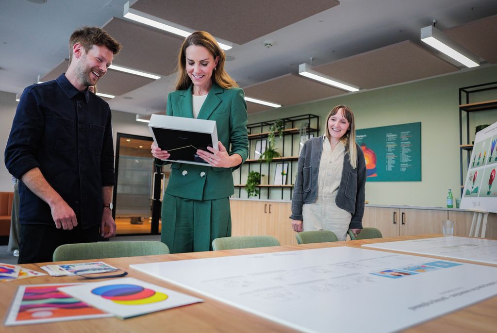 Princess Kate in green suit looking at animations