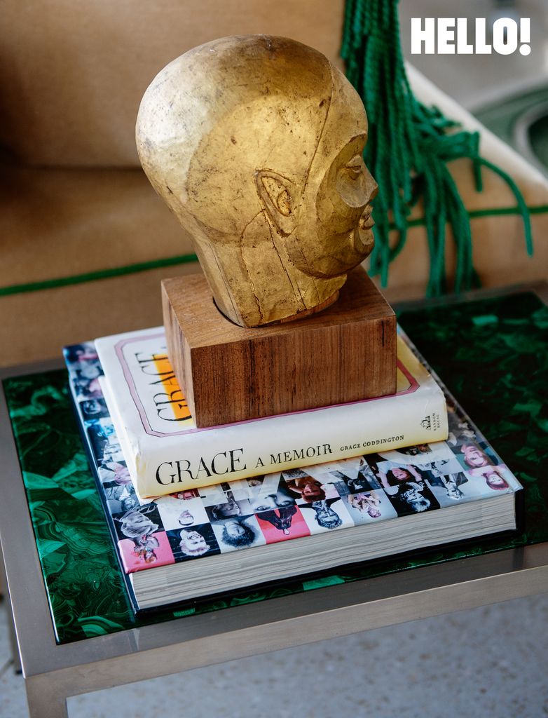 A gold stone head on top of decorative books on a coffee table in the three-storey apartment in Antwerp’s Graanmarkt Square