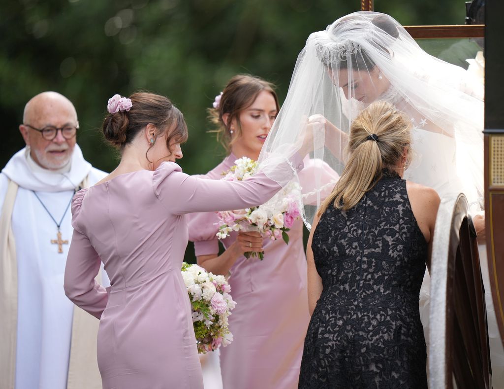 Lady Violet was helped out of the car by her bridesmaids