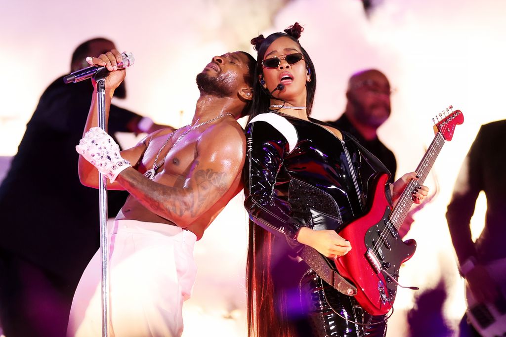 Usher and H.E.R. perform onstage during the Apple Music Super Bowl LVIII Halftime Show at Allegiant Stadium on February 11, 2024 in Las Vegas, Nevada