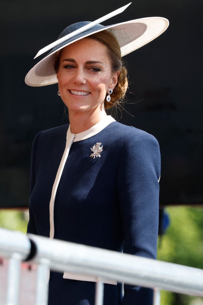 Kate Middleton smiling in navy dress and hat while in Glasgow for HMS naming ceremony