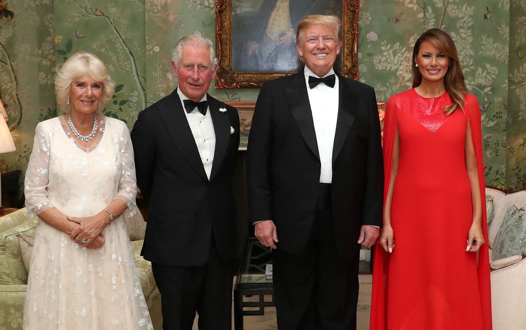 Queen Camilla, King Charles, Donald Trump and Melania Trump wearing smart eveningwear in a drawing room
