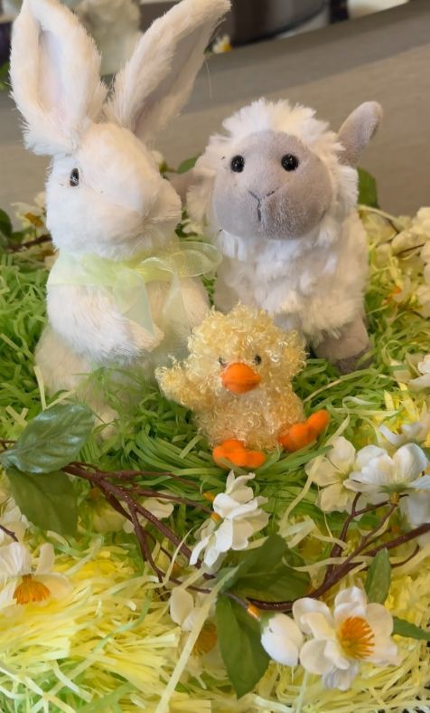A plush bunny, sheep and chick on a grass wreath