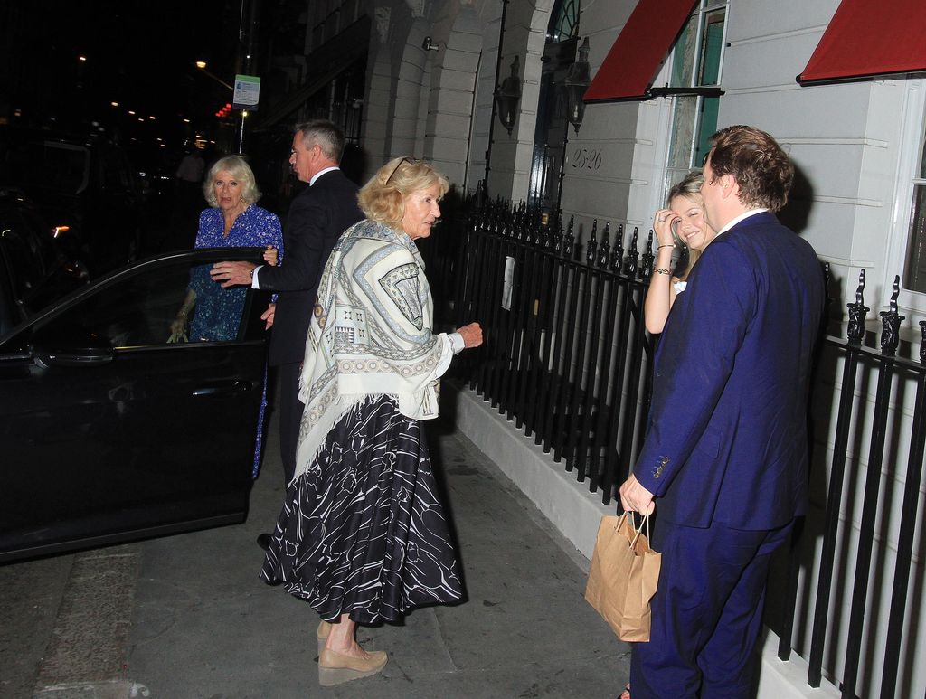 Tom Parker-Bowles stood outside a car as Queen Camilla gets in it