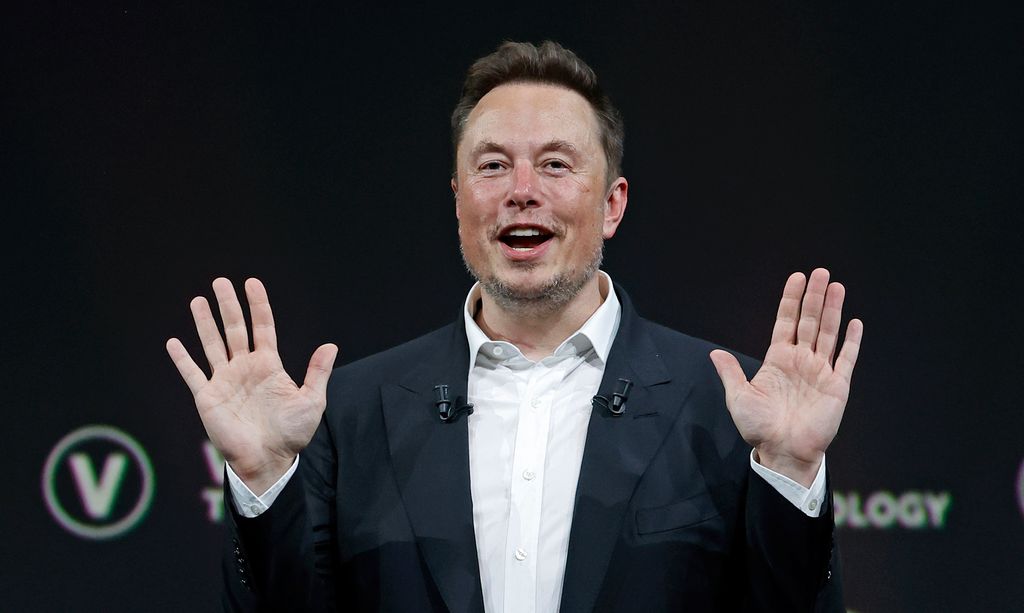 elon musk holding his hands up
