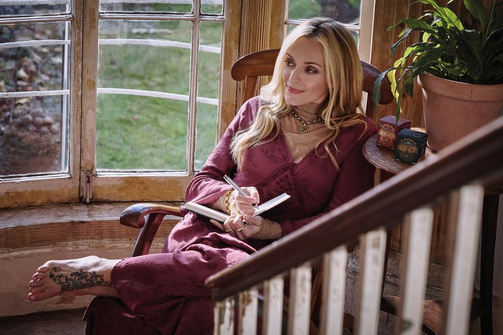 Fearne Cotton in burgundy sitting on a wooden chair 