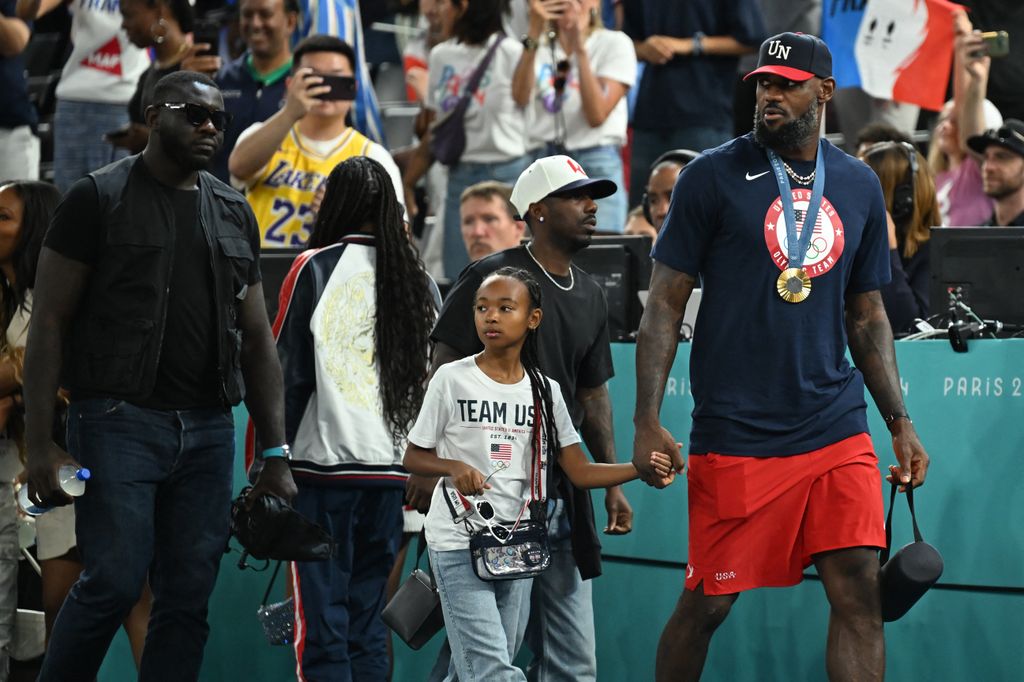 LeBron James arrives with his daughter Zhuri to watch the women's Gold Medal basketball match between France and the USA during the Paris 2024 Olympic Games at the Bercy  Arena in Paris on August 11, 2024