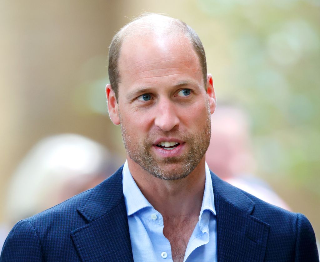 Prince William wearing open collared shirt and blazer