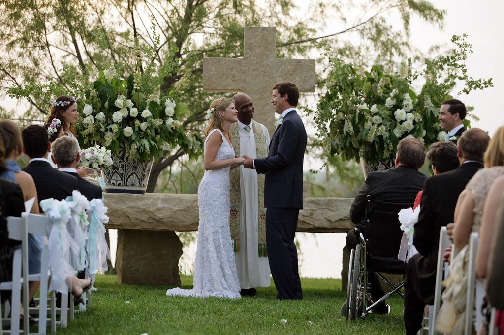 In this handout image provided by the White House, Henry Hager and Jenna Bush exchange vows at the altar at Prairie Chapel Ranch as Rev. Kirbyjohn Caldwell (C) presides May 10, 2008 near Crawford, Texas