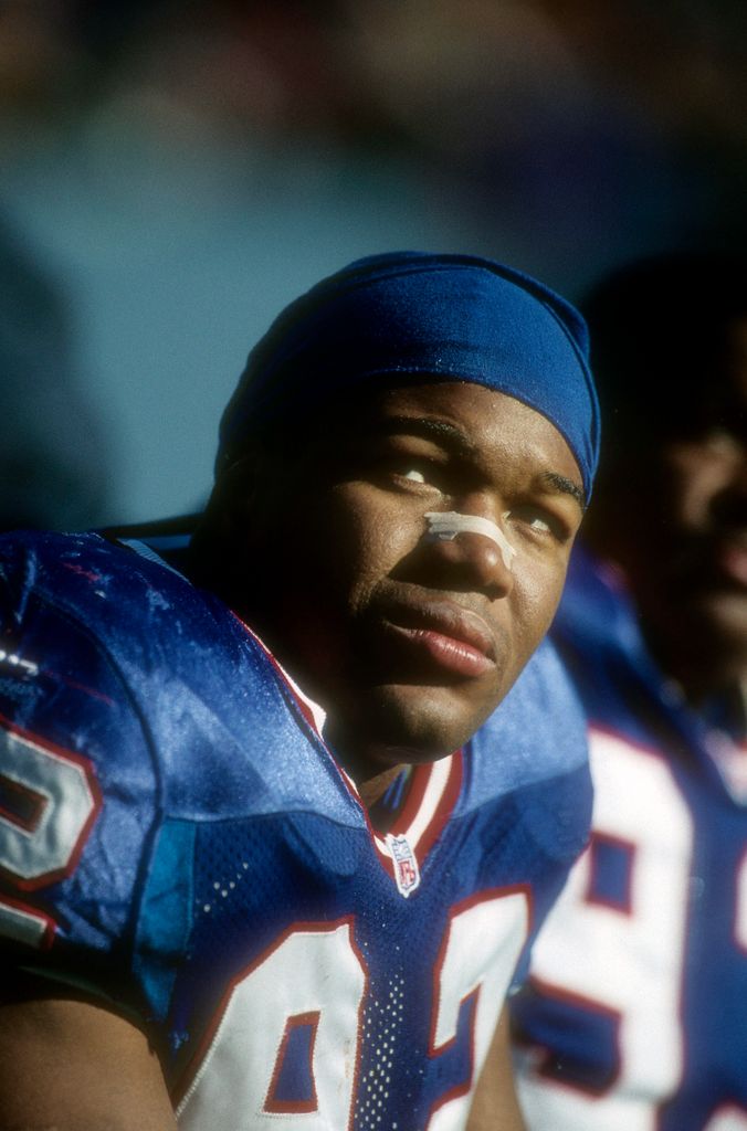 Defensive End Michael Strahan #92 of the New York Giants follows the action in the game between the New England Patriots vs the New York Giants at Giants Stadium on December 21, 1996 in East Rutherford, New Jersey