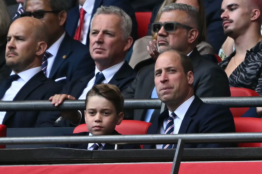 Prince George of Wales (L) and Britain's Prince William, Prince of Wales attend the English FA Cup final football match 