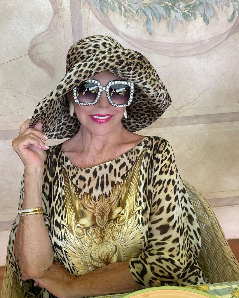 A photo of Joan Collins wearing a full leopard print outfit