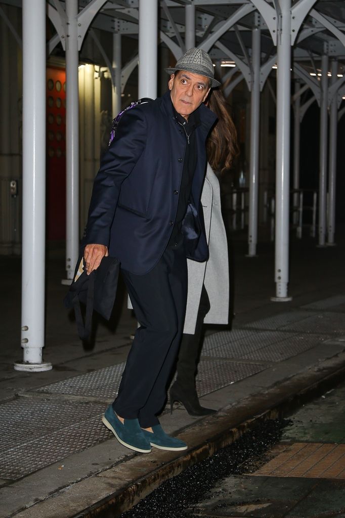 George Clooney and his wife Amal Clooney hold hands as they head out together in New York.