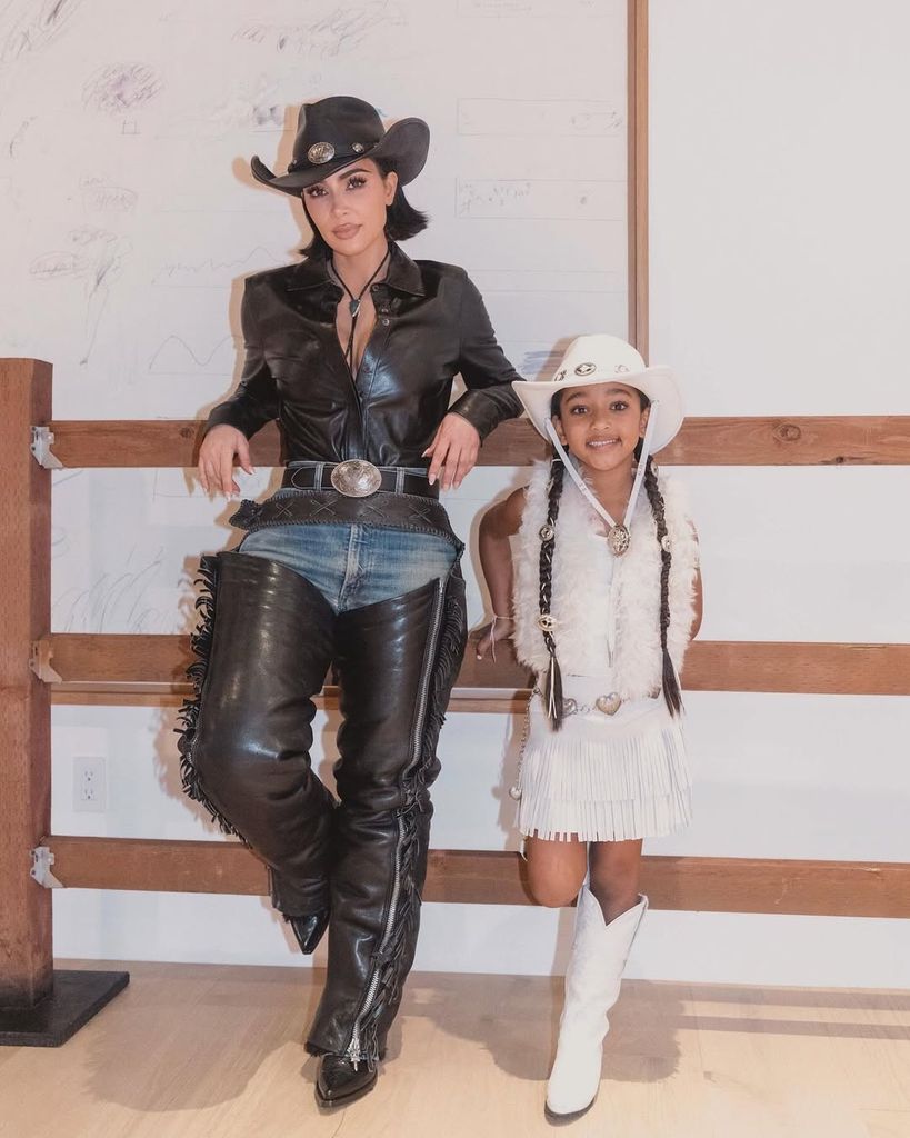 Kim Kardashian and Chicago West in cowboy outfits posing next to each other 