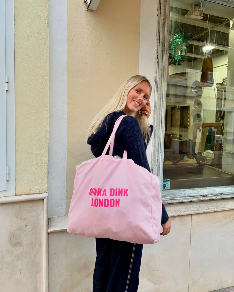 minnie roydon with branded pink tote