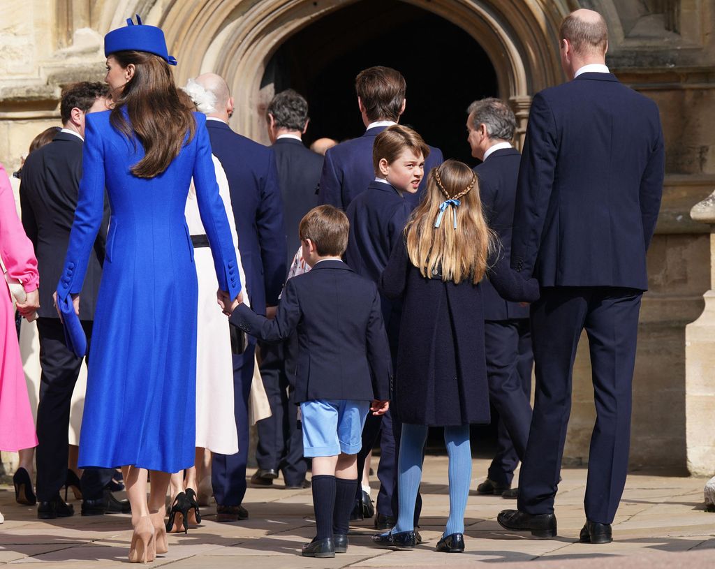 Prince George looks back at his family ahead of the Easter church service