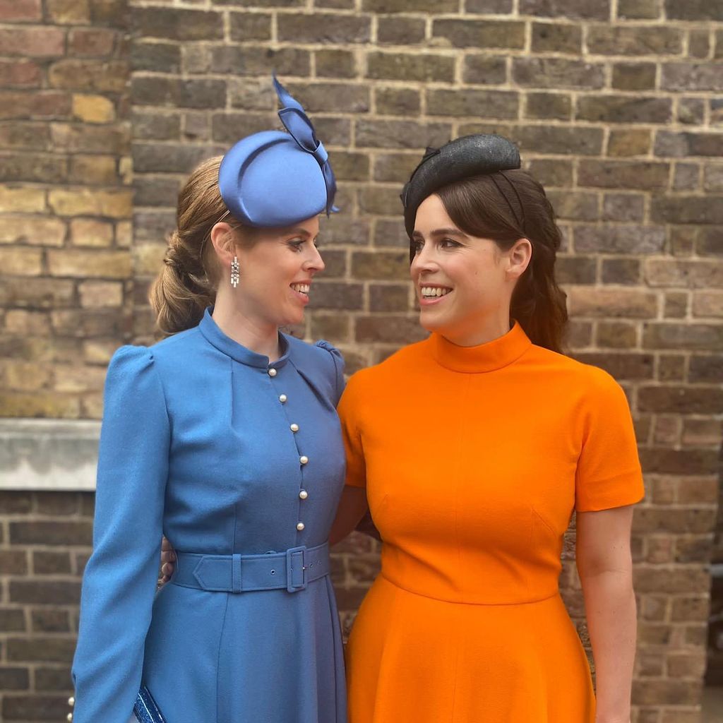 Princess Beatrice wearing blue dress and Princess Eugenie wearing orange dress
